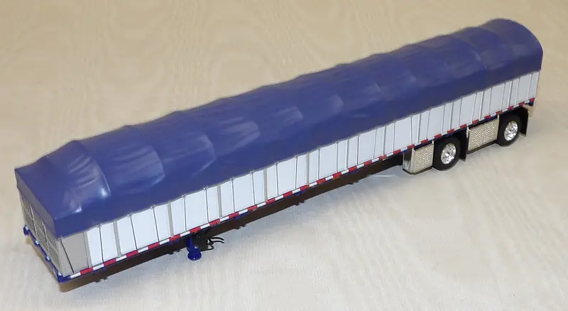 1/64 Scale Blue and White Wilson Roadbrute 53′ Flatbed Spread-Axle Trailer with Covered Wagon #620572