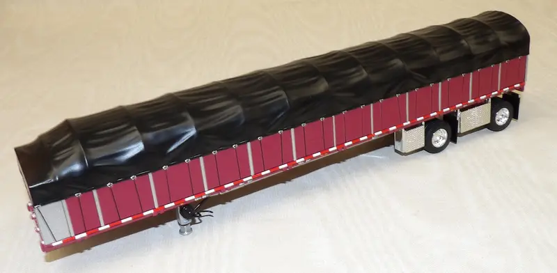 1/64 Scale Maroon and Black Wilson Roadbrute 53′ Flatbed Spread-Axle Trailer with Covered Wagon #620582